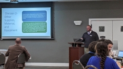 CTE Workshop Speaker at Podium standing in front of seated attendees, November 16, 2022